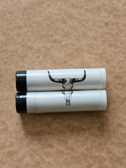 Black sihilloute of a adhorn bull skull on a white back ground wrapped around a lip balm tube. 